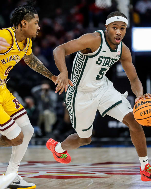 Michigan State guard Tre Holloman (5) dribbles against Minnesota guard Elijah Hawkins (0) during the second half of Second Round of Big Ten tournament at Target Center in Minneapolis, Minn. on Thursday, March 14, 2024.